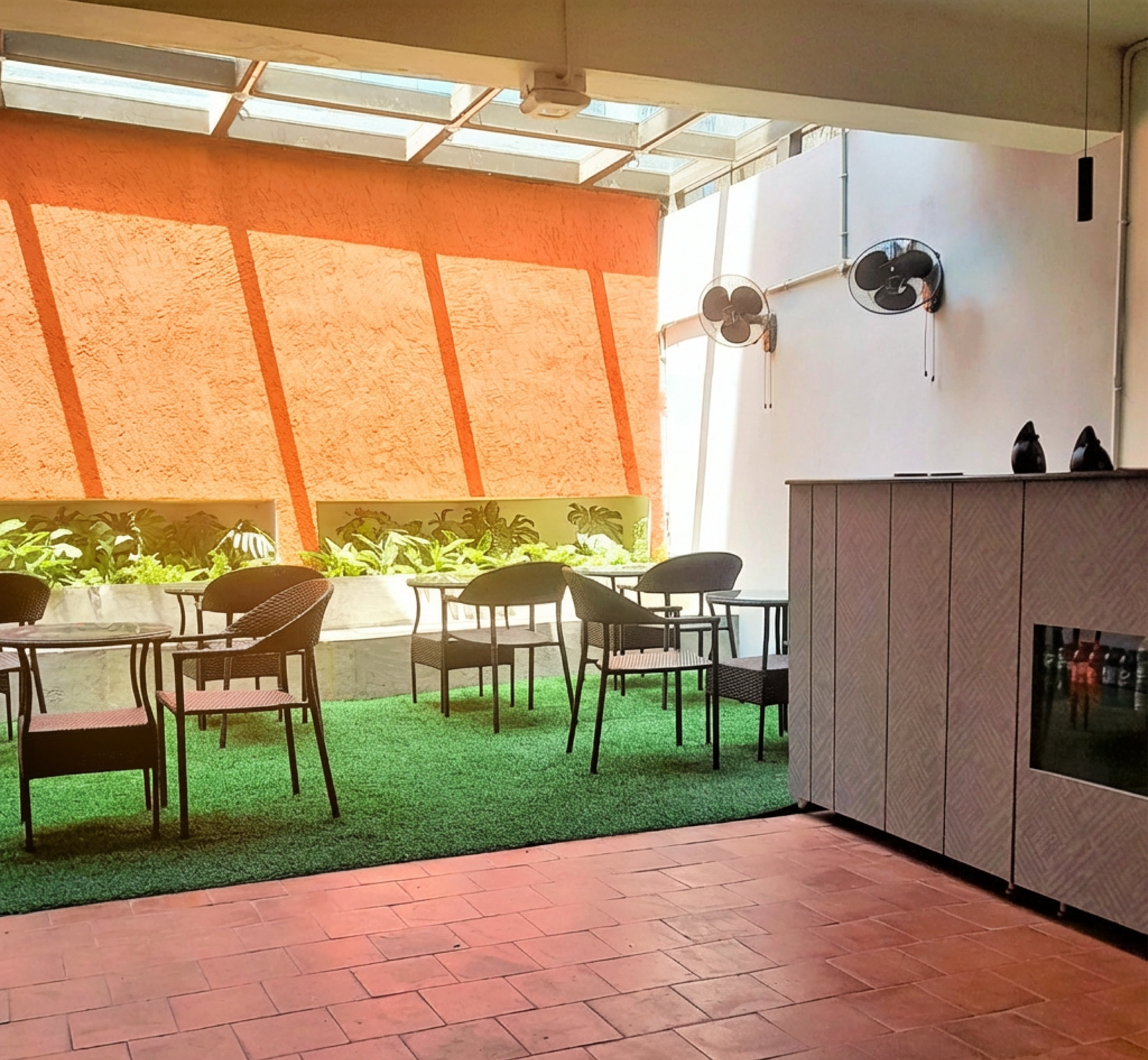Cafeteria with chair, table & greenery in managed office